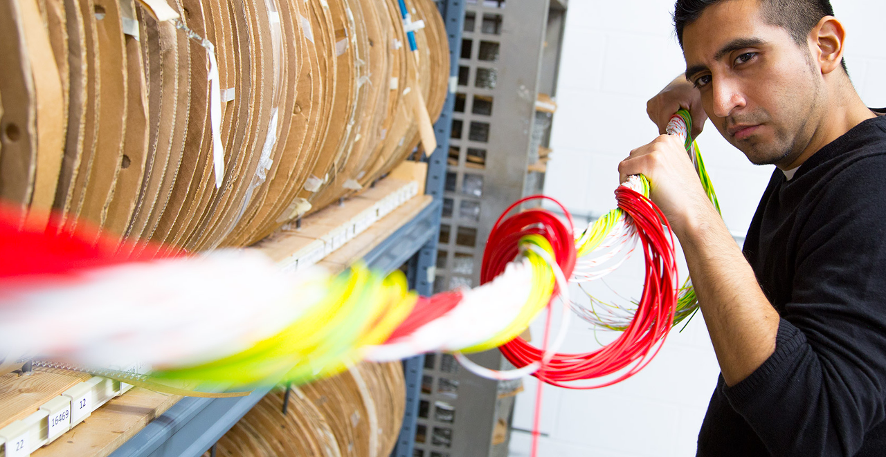 A picture of an EMSCO technician manipulating wire cables.